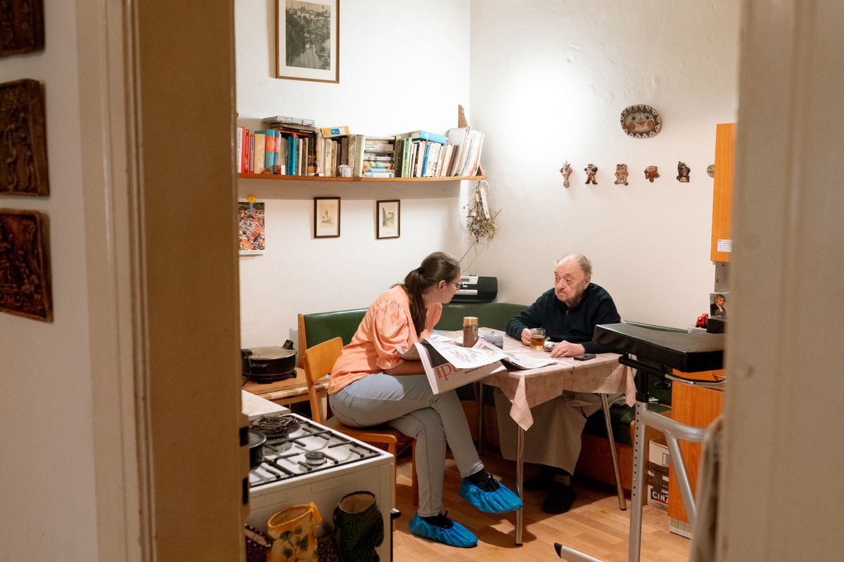 A caregiver spending warm, attentive time with a senior client at home