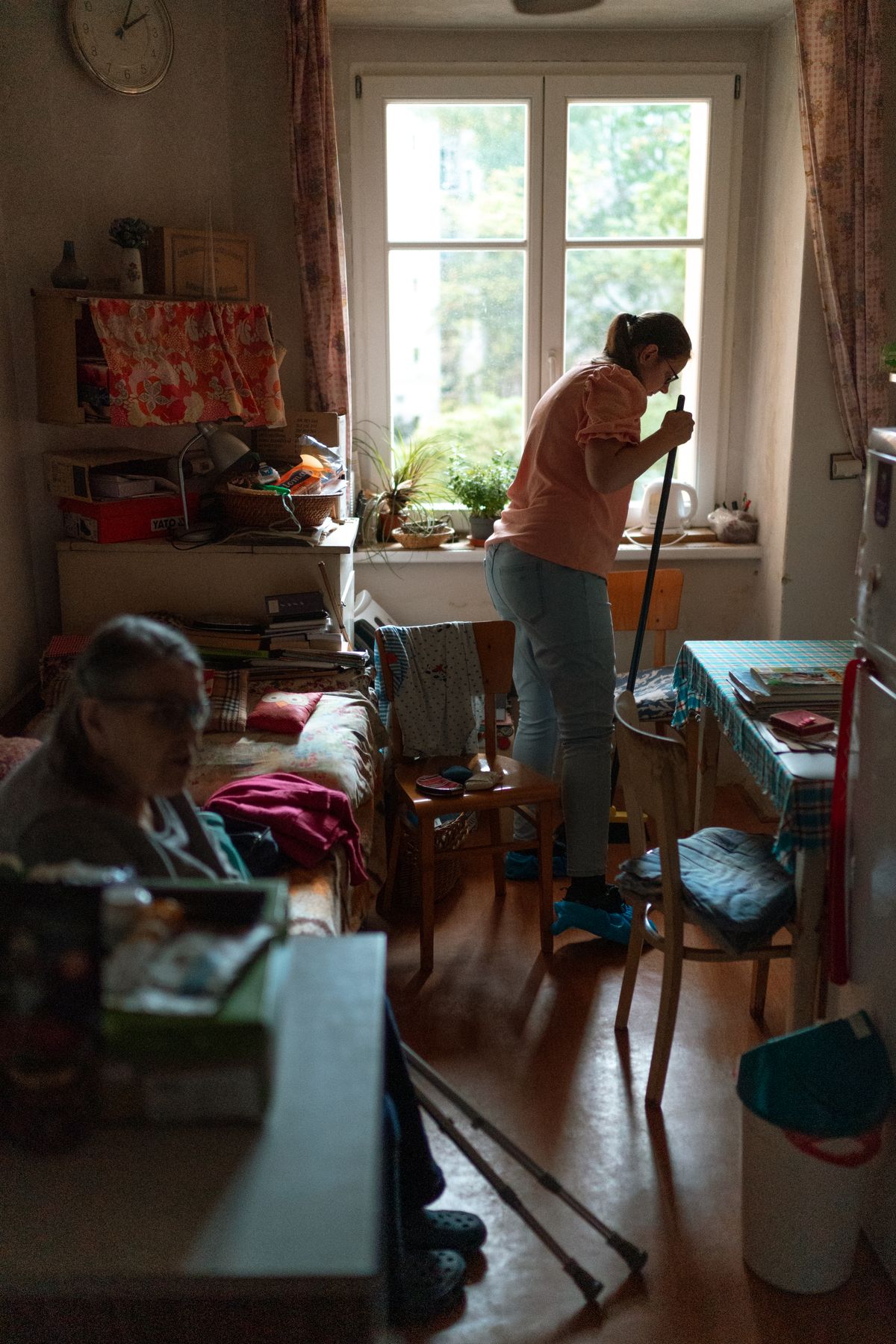 A caregiver tidying and maintaining a clean, welcoming home